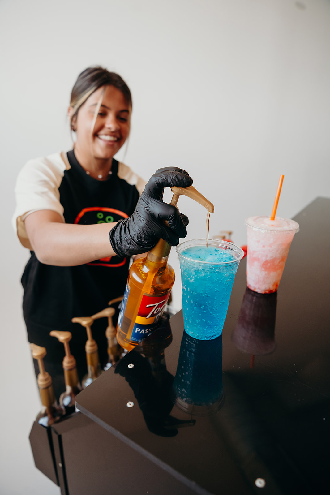 A Thirst team member pouring syrup into a dirty soda at a catered event