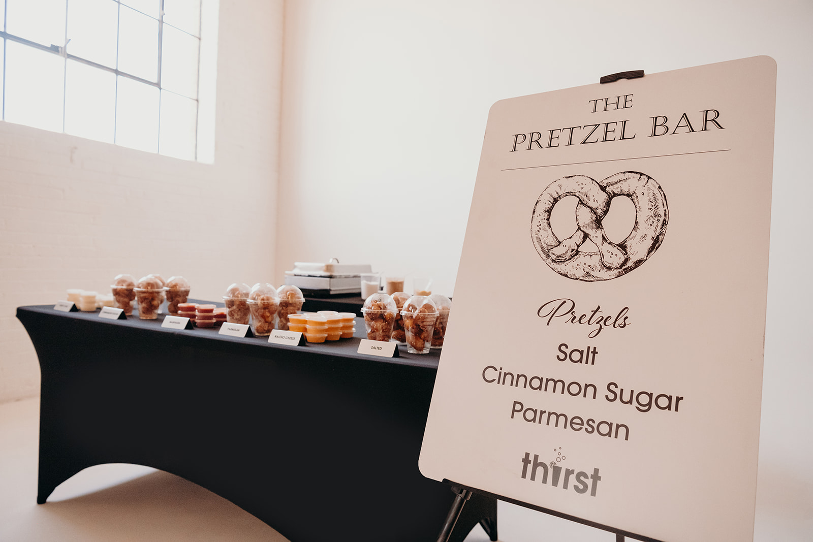 The Thirst Pretzel Bar display with labeled toppings and dipping sauces