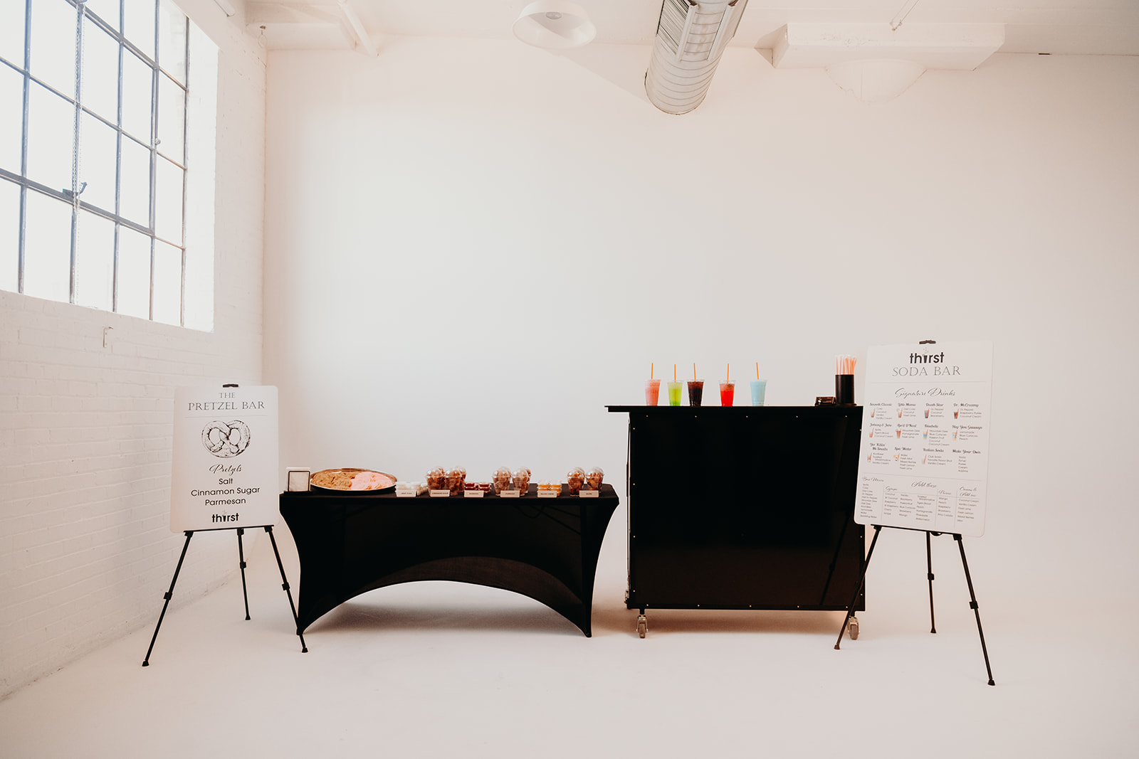A full Thirst catering setup with the Pretzel Bar and Soda Bar in a wedding venue