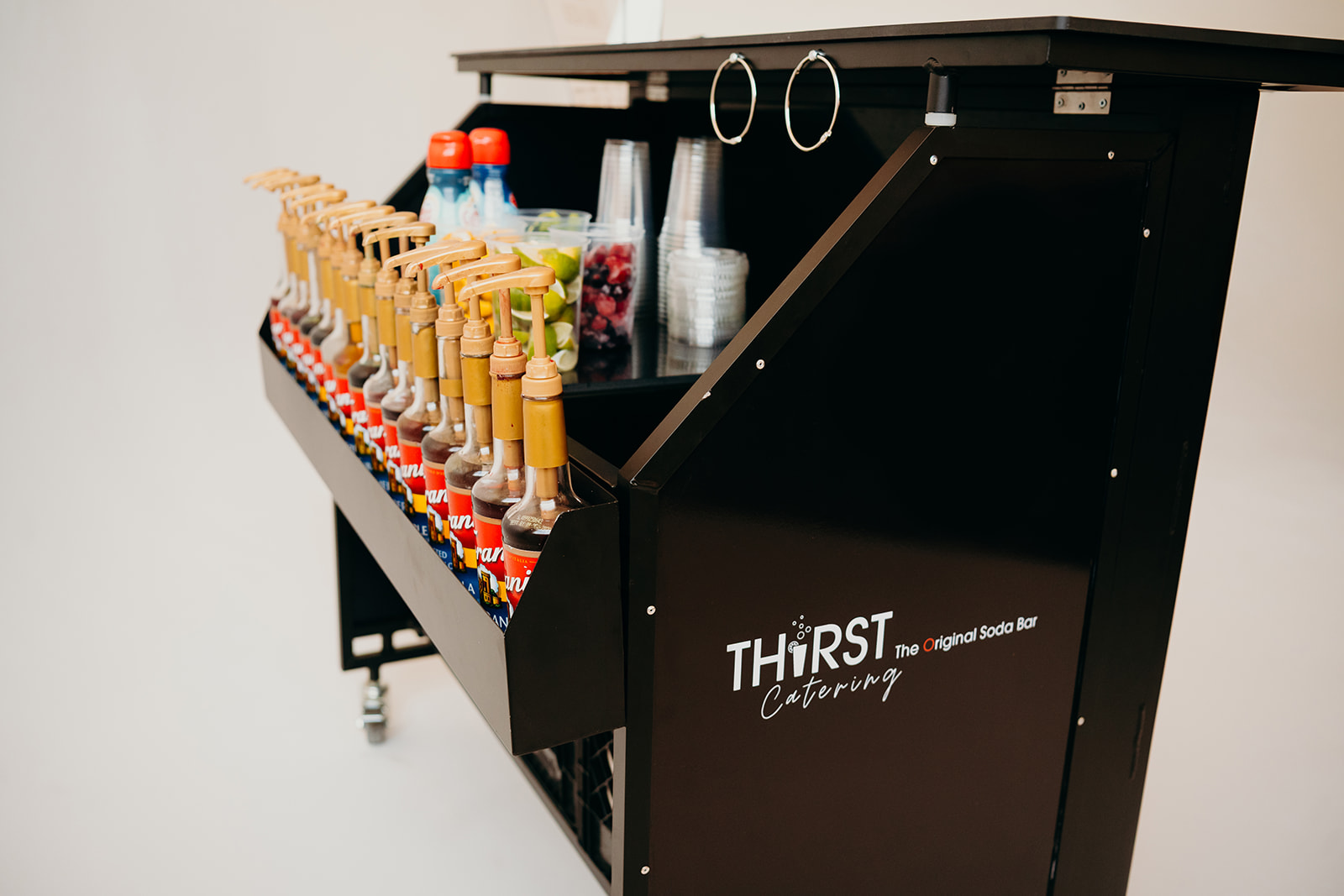 The Thirst mobile soda bar stocked with syrup flavors and fresh garnishes